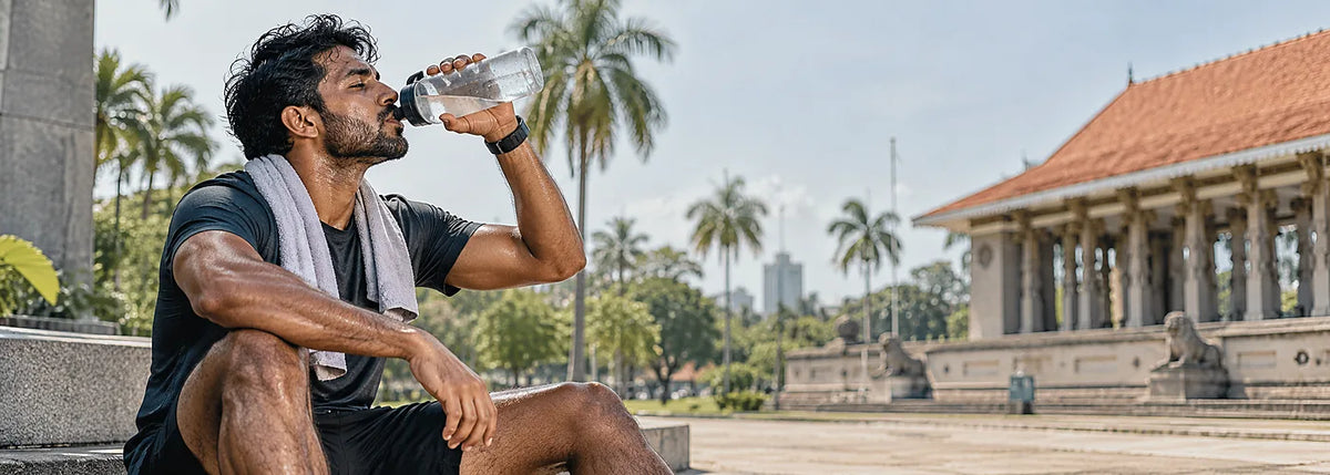 South Asian athlete hydrating during sport in Sri Lankan heat with electrolytes