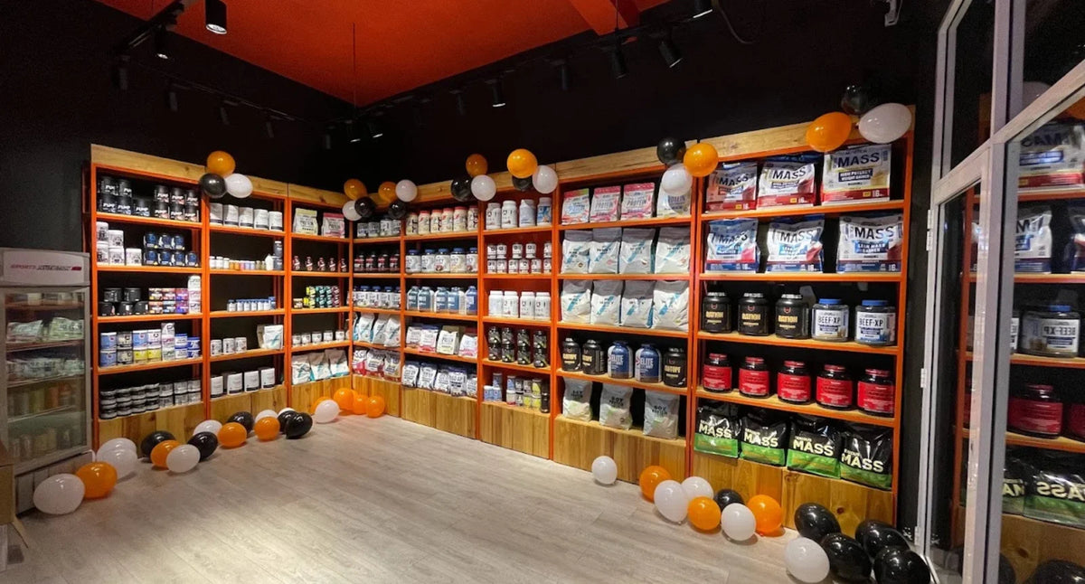 Interior of the SNH Dehiwala showroom with orange shelves displaying sports nutrition products